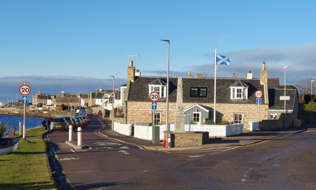 Looking down road towards home with saltire flagpole in garden.