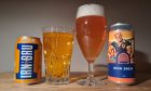 A can of Irn Bru soft drink poured into a glass, and a can of Iron Brew sour beer from Vault City poured into another glass.