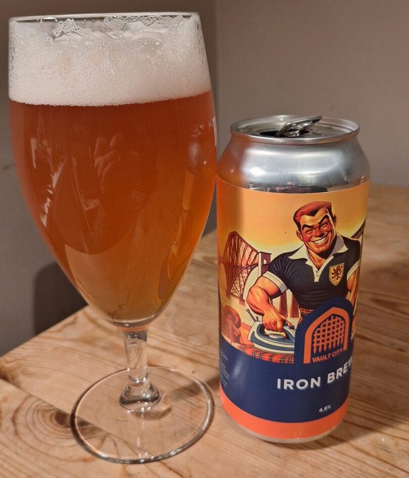 The can artwork of Iron Brew, alongside a glass full of the Irn Bru beer. 