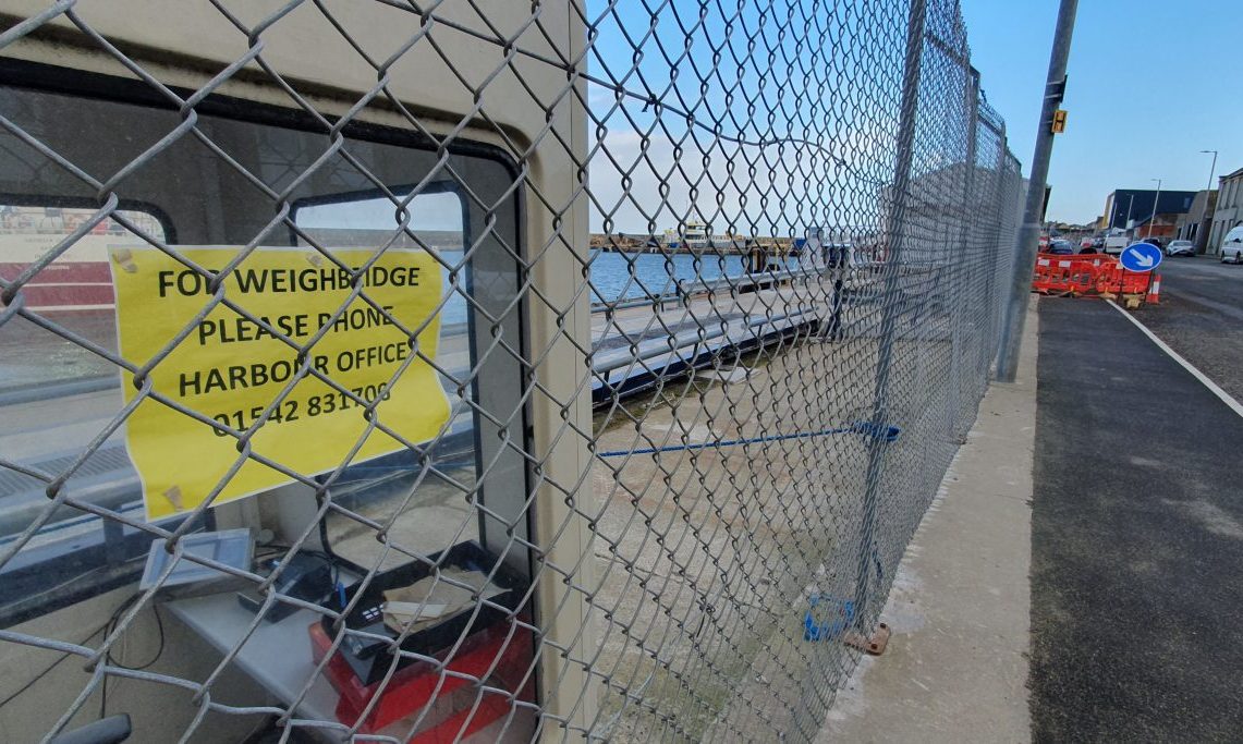 Weighbridge behind fencing. 