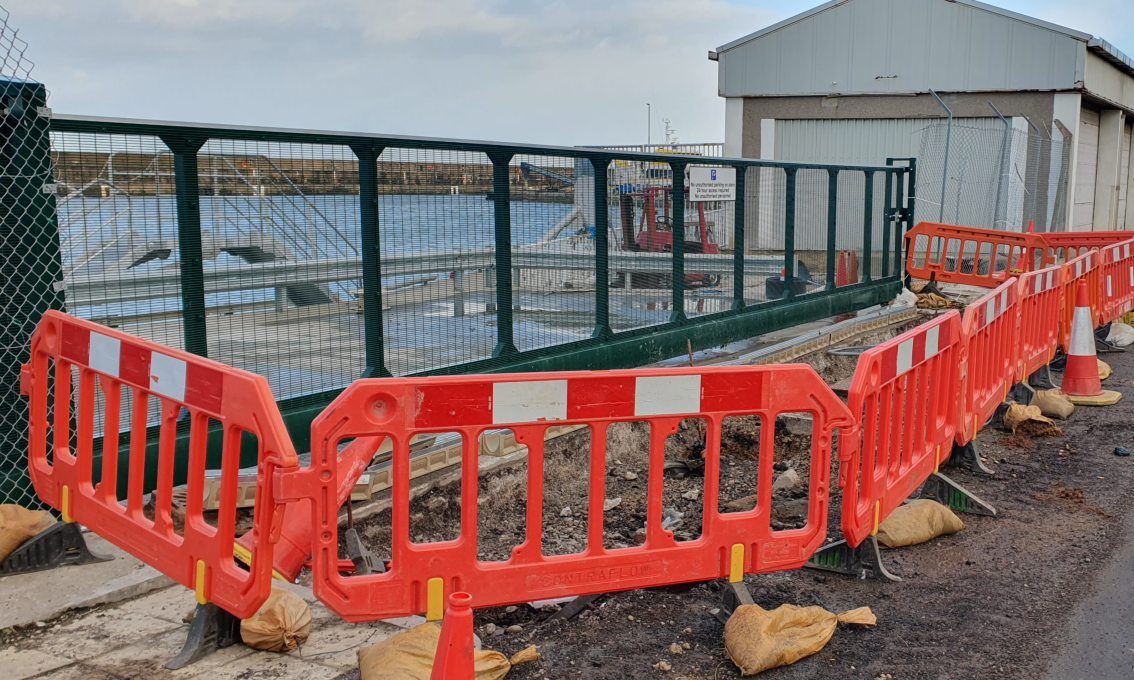 Gate at Buckie harbour weighbridge surrounded by roadworks. 