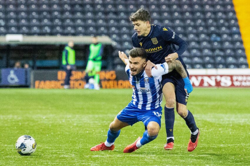 Kilmarnock's Daniel Armstrong and Dundee's Owen Beck battle for possession