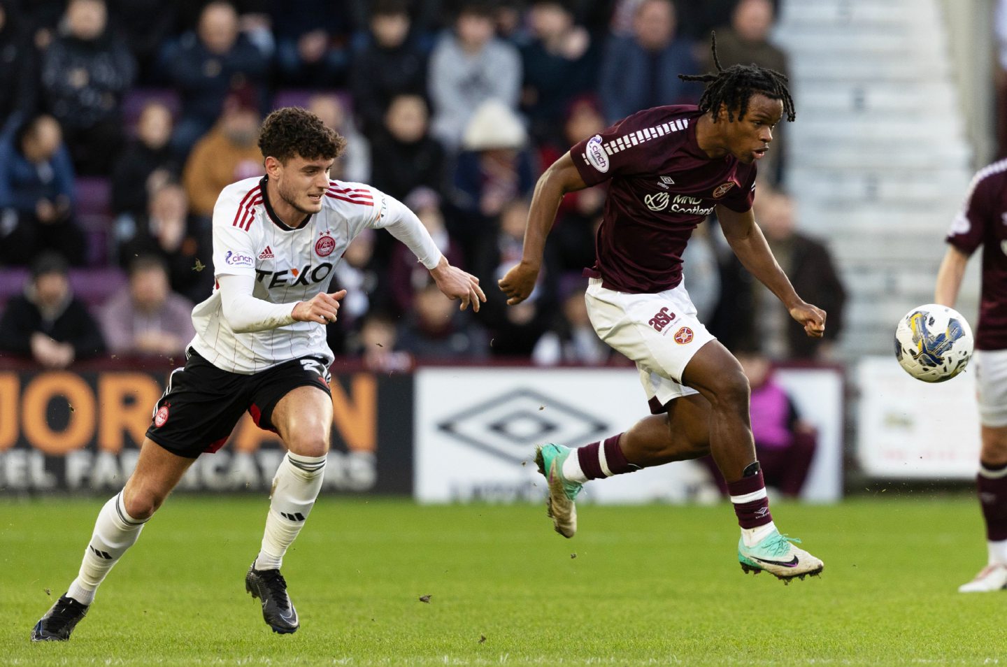 Hearts' Dexter Lembikisa and Aberdeen's Dante Polvara in action at Tynecastle. Image: SNS
