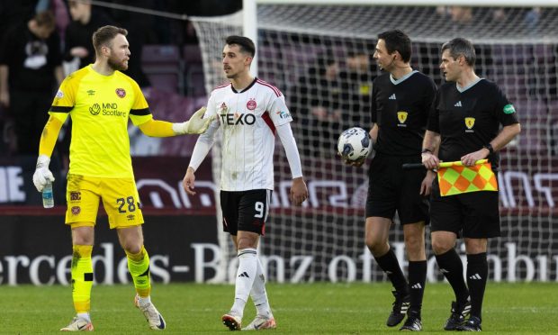 Hearts' Zander Clark, Aberdeen's Bojan Miovski and referee Kevin Clancy in discussion at half time of the Premiership match between Heart of Midlothian and Aberdeen at Tynecastle. Image: SNS.