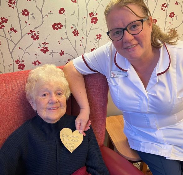 A resident and staff member at a Meallmore care home.