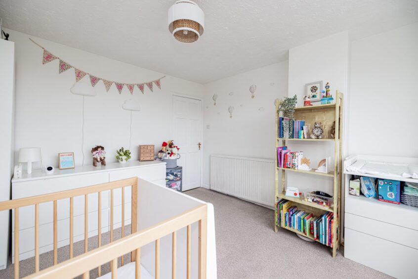 Crisp whites and pretty interiors create a peaceful and soothing ambience in the kids bedroom.