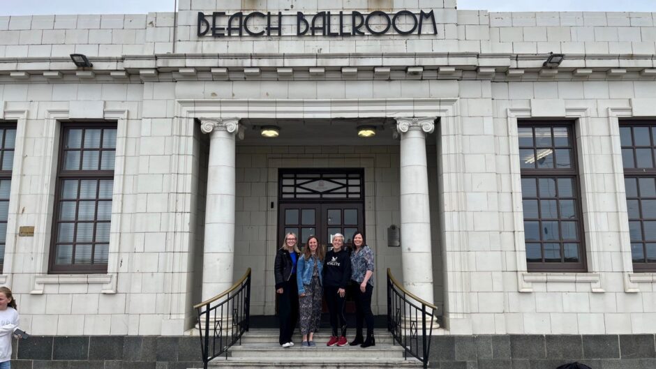 Chloe Cameron from SLB, the event sponsors with festival organisers Sarah Stewart and Dr. Emma Windle and Nuala McClenaghan also from SLB standing in the doorway of the Beach Ballroom