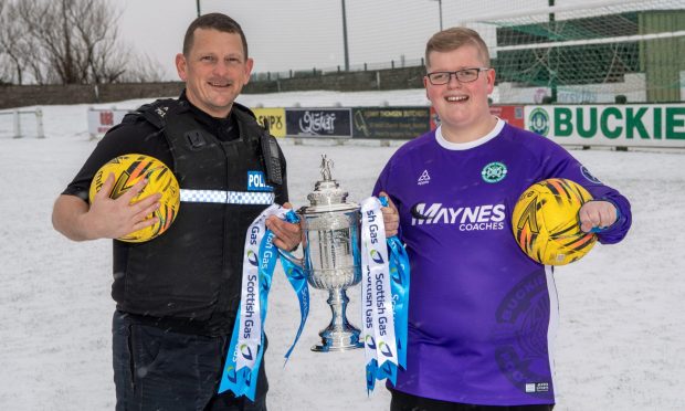 Buckie Thistle goalkeeping coach Darren Strong, left, and son Daniel with the Scottish Cup at Victoria Park.