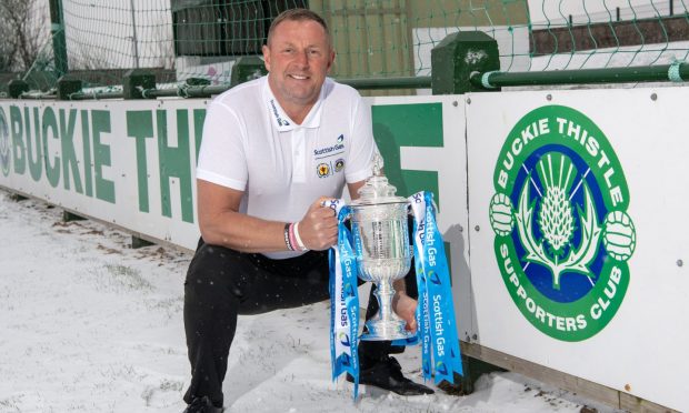 Rab Douglas, pictured at Buckie Thistle's ground Victoria Park, with the Scottish Cup.