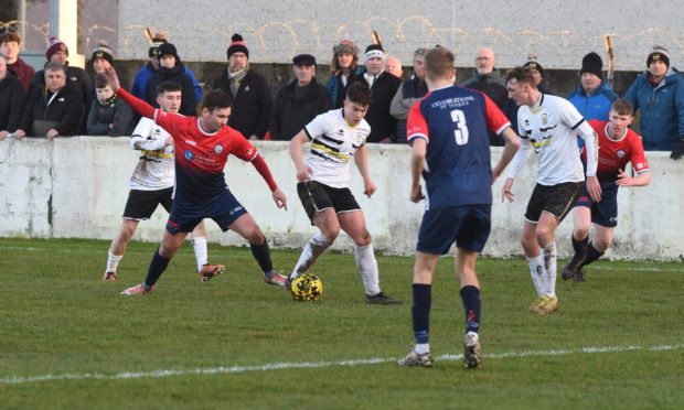 Turriff United's Liam Strachan, left, challenges Fergus Adams of Clachnacuddin. Puc