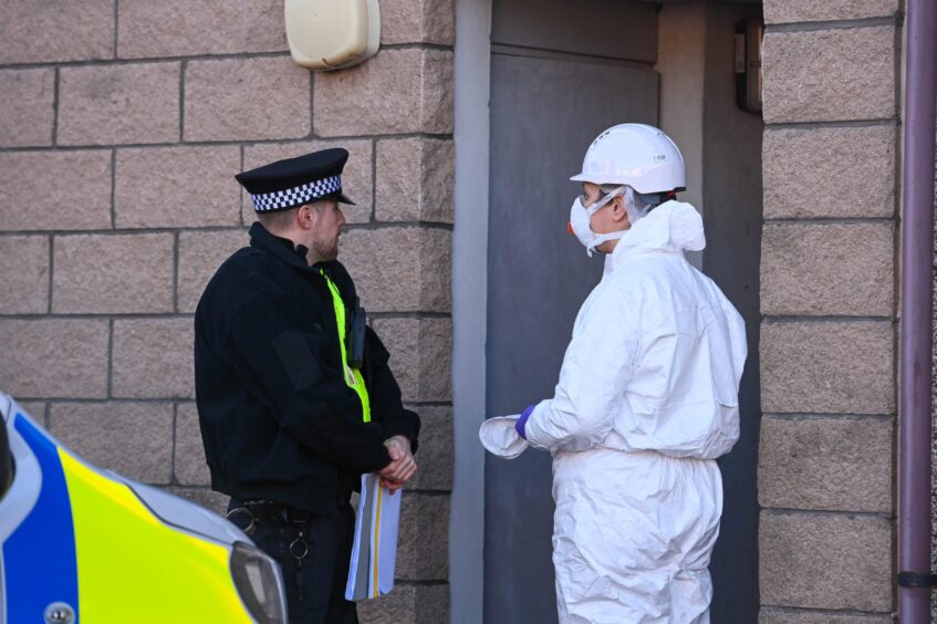 Officers outside flats on Back Hilton Road to investigate fire.