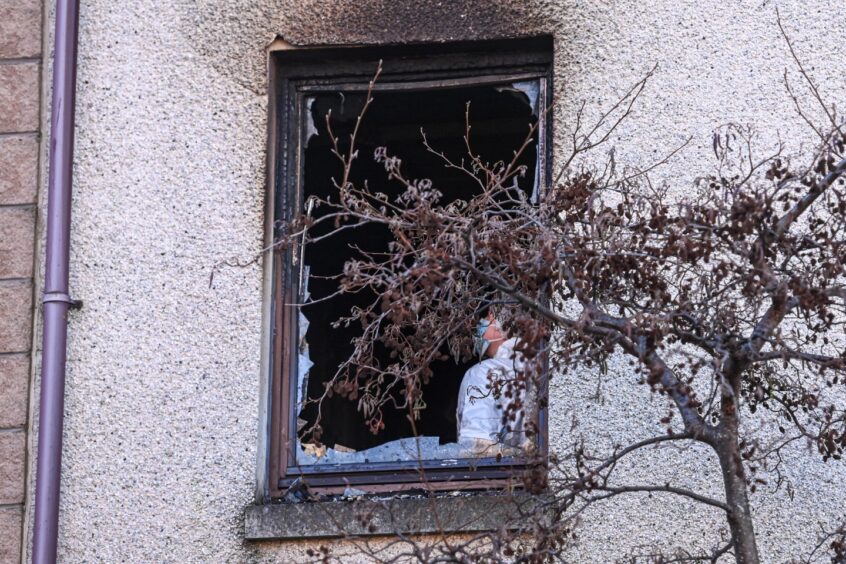 Broken window caused by fire at block of flats in Hilton, Aberdeen.