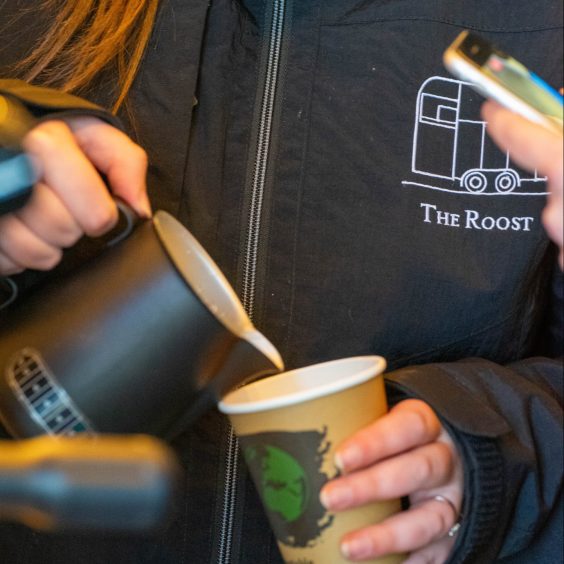 A picture of a The Roost barista pouring a coffee