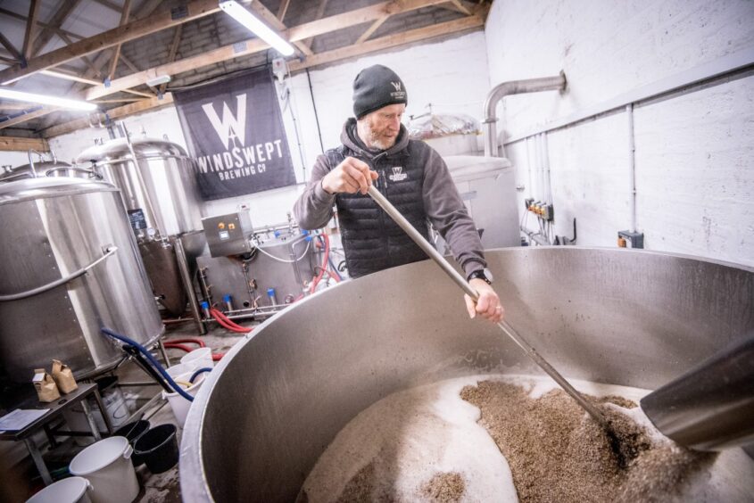 A brewer making beer. 