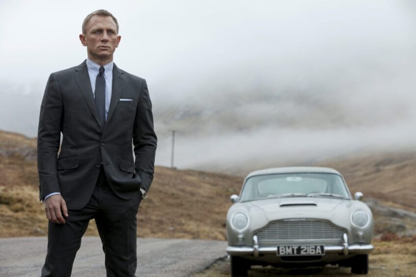 Daniel Craig stars as James Bond, taking in the spectacular scenery of Glen Coe, in Skyfall. 