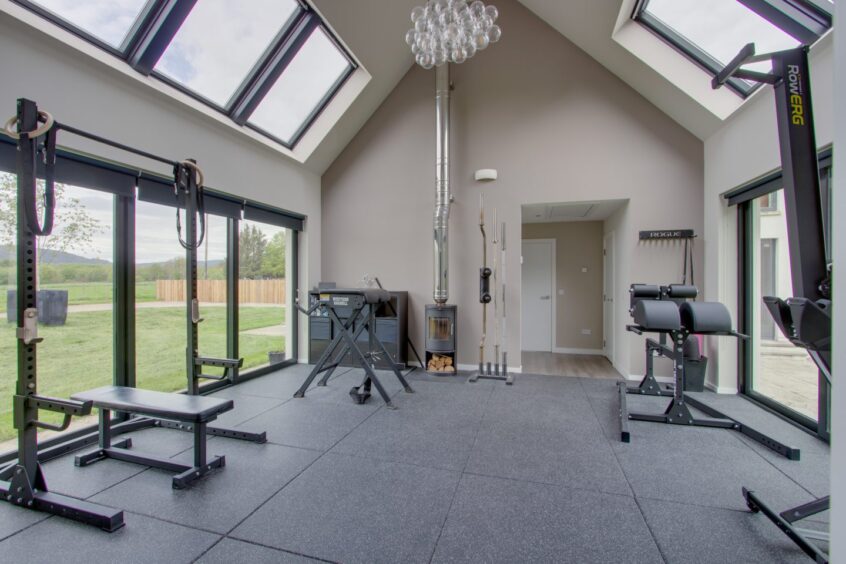 Room with high ceilings in Drumview House with gym equipment 