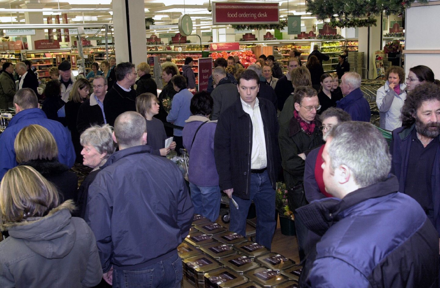 Christmas Eve shoppers queuing at the entrance to the shop