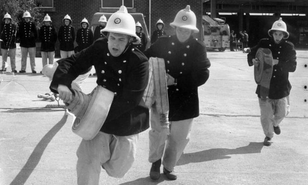 1978: New recruits on their eighth day of fire training at Grampian HQ were instructed on hose drill on a sunny August day. At this time, Grampian Fire Brigade was the only force in Scotland to have a full complement of men. Image: DC Thomson