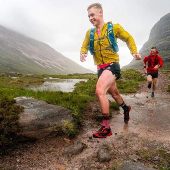 Robin Downie runs through some muddy puddles in the mountains.