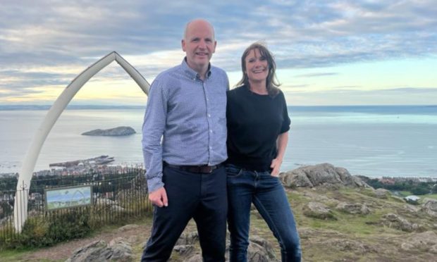 Glenn Campbell with wife Claire at Whale Bone Arch on top of North Berwick Law