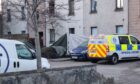Police remain at a block of flats in Aberdeen. Image: DC Thomson