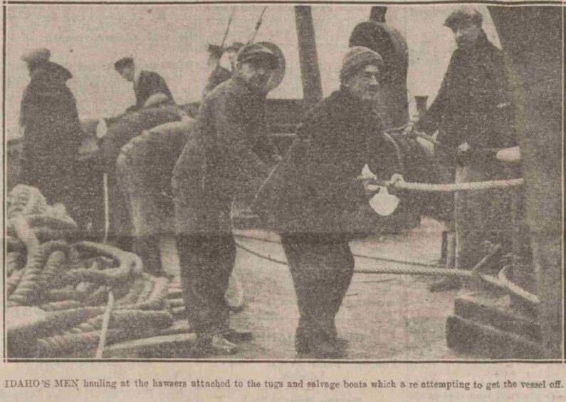 SS Idaho crew hauling at the jawsers attached to the tugs and salvage boats.