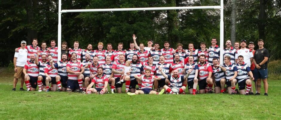 Moray rugby club players in rows underneath the posts