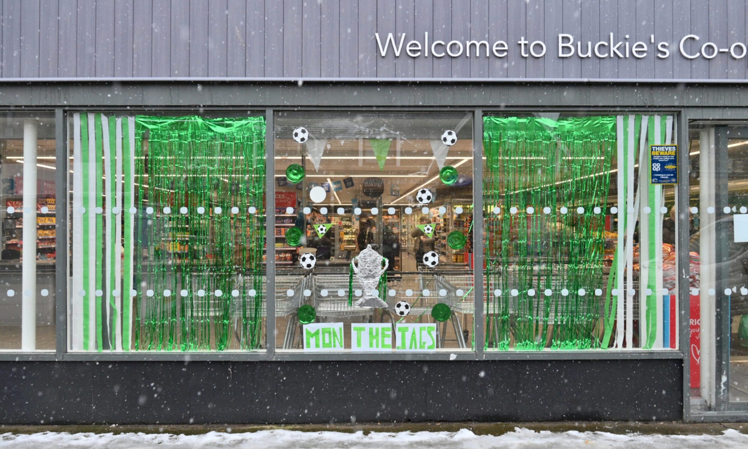 Green and white decorations in Co-op window. 