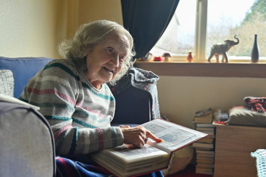 Holocaust survivor Kathy Hagler of Inverness pictured at home looking through her photo albums. 