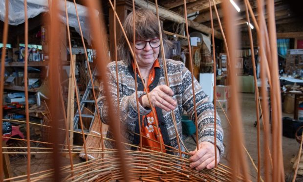 Karen Collins working at weaving willow coffin.