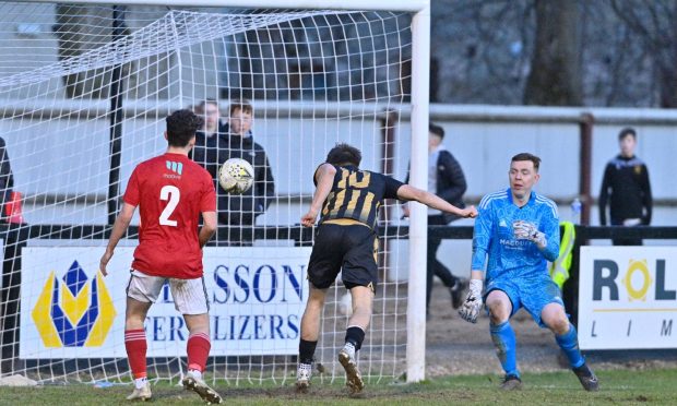 Angus Grant, centre, scores Huntly's fourth against Deveronvale. Pictures by Jason Hedges/DCT Media.