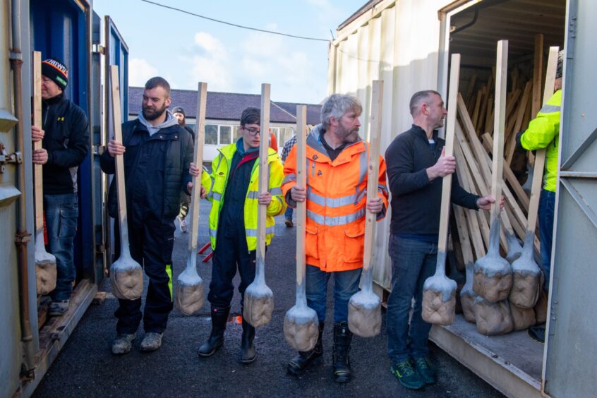 A group of volunteers work to get more than 1,000 torches ready for Up Helly Aa