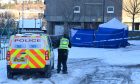 Blue tent and police van outside Elphinstone Court