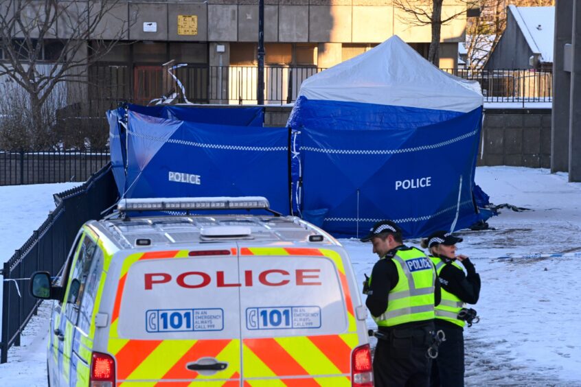 Police van in front of blue tent 