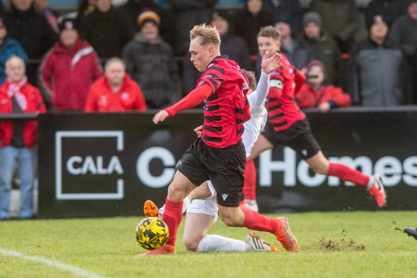 Inverurie's Nathan Meres tries to evade a tackle.