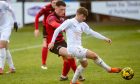 Brora's James Wallace shields the ball from Inverurie Locos' Lloyd Robertson. Image: Kath Flannery/DC Thomson