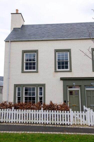 The new build in Chapelton, Aberdenshire, featuring a white and green exterior.