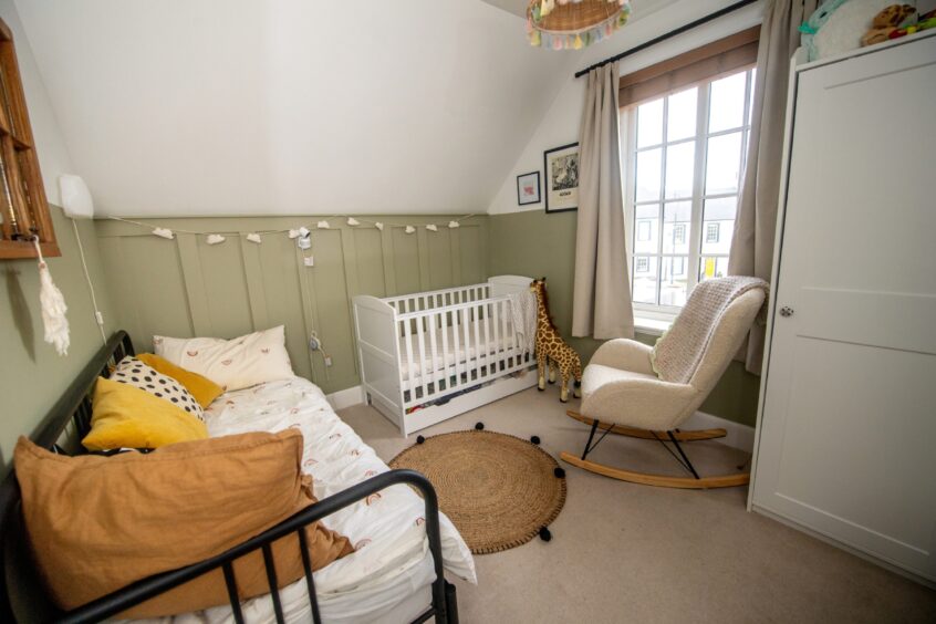 Cosy child's bedroom inside the Chapelton property, featuring sage green and white colour scheme.