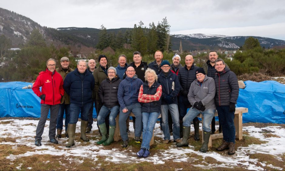 Volunteers, photographed in front of the newly installed flood defence in Ballater.