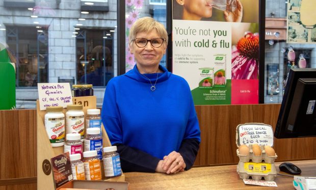 Catherine Eddie behind the counter