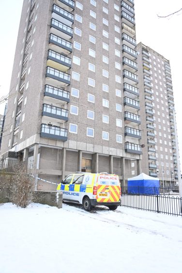 Police outside block of flats in aberdeen where a man jumped out the window after experiencing torture to 'atone' for theft.