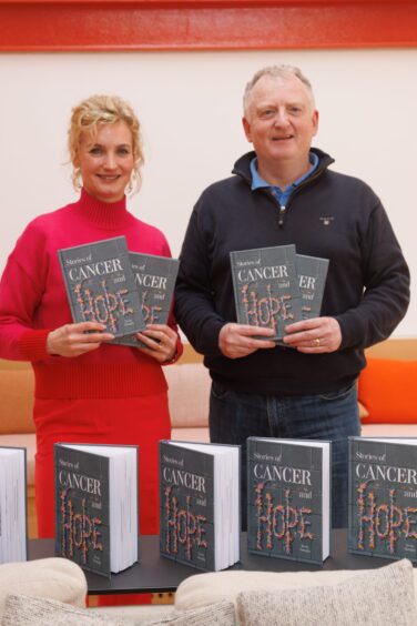 Kevin with Maggie's chief executive Laura Lee and the book Stories of Cancer and Hope