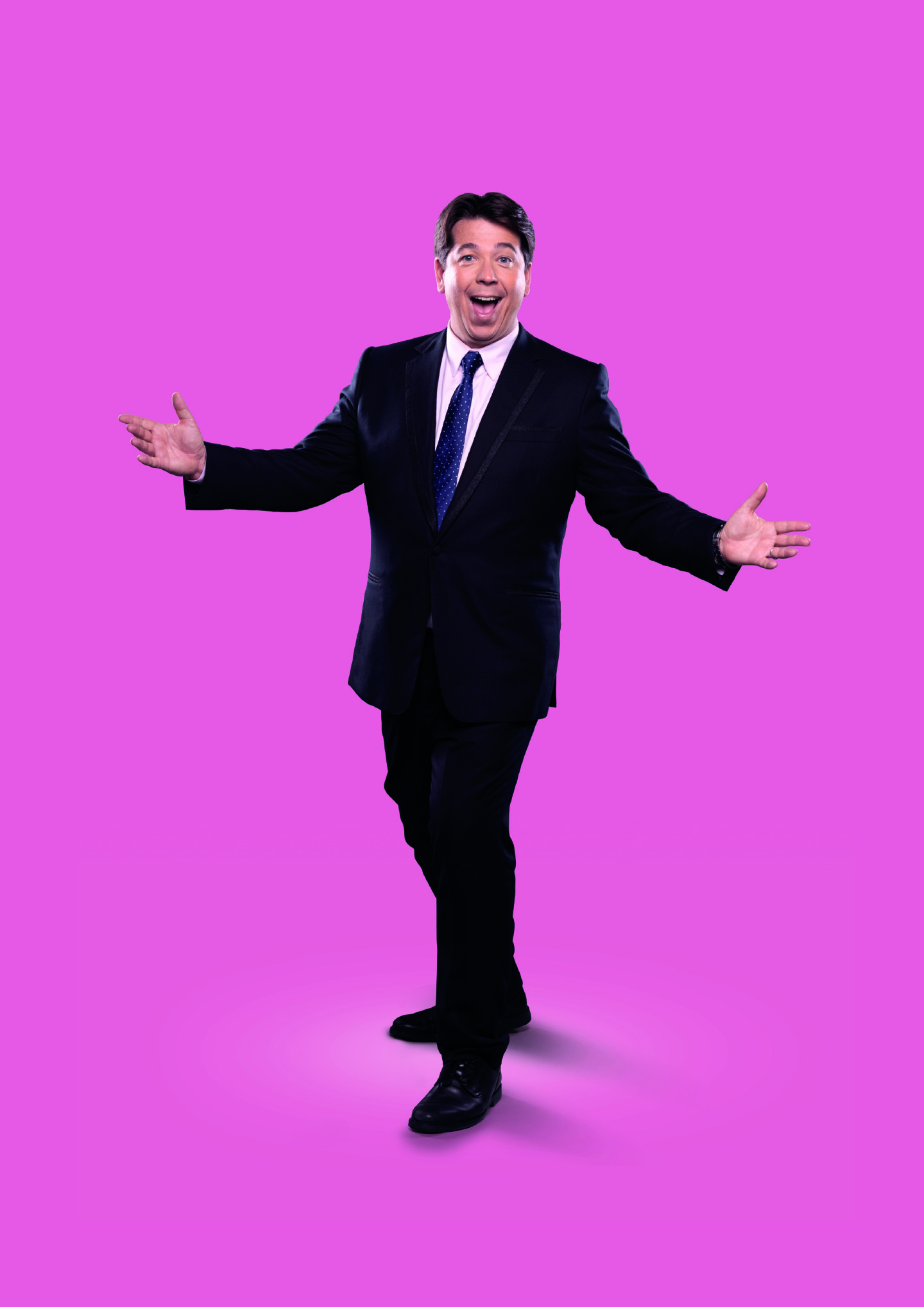 Michael McIntyre on a pink background for his new tour.