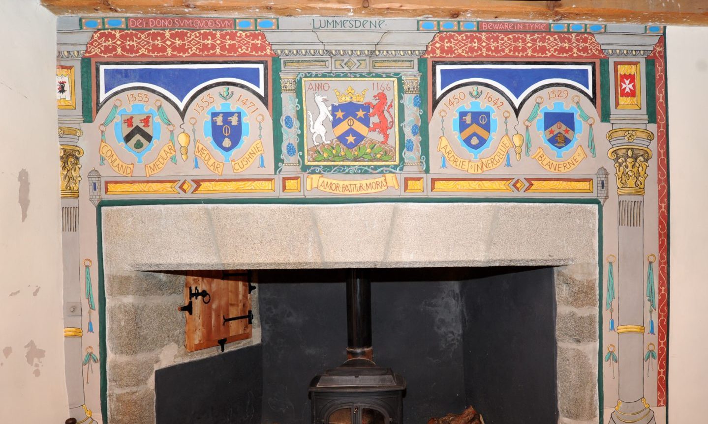 Clan crests above the fireplace inside the castle