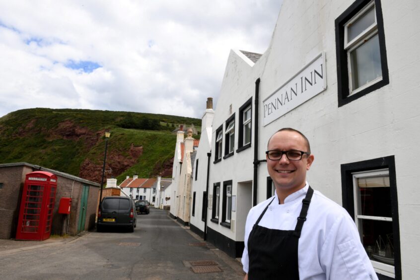 Owner Peter Simpson in front of the Pennan Inn.