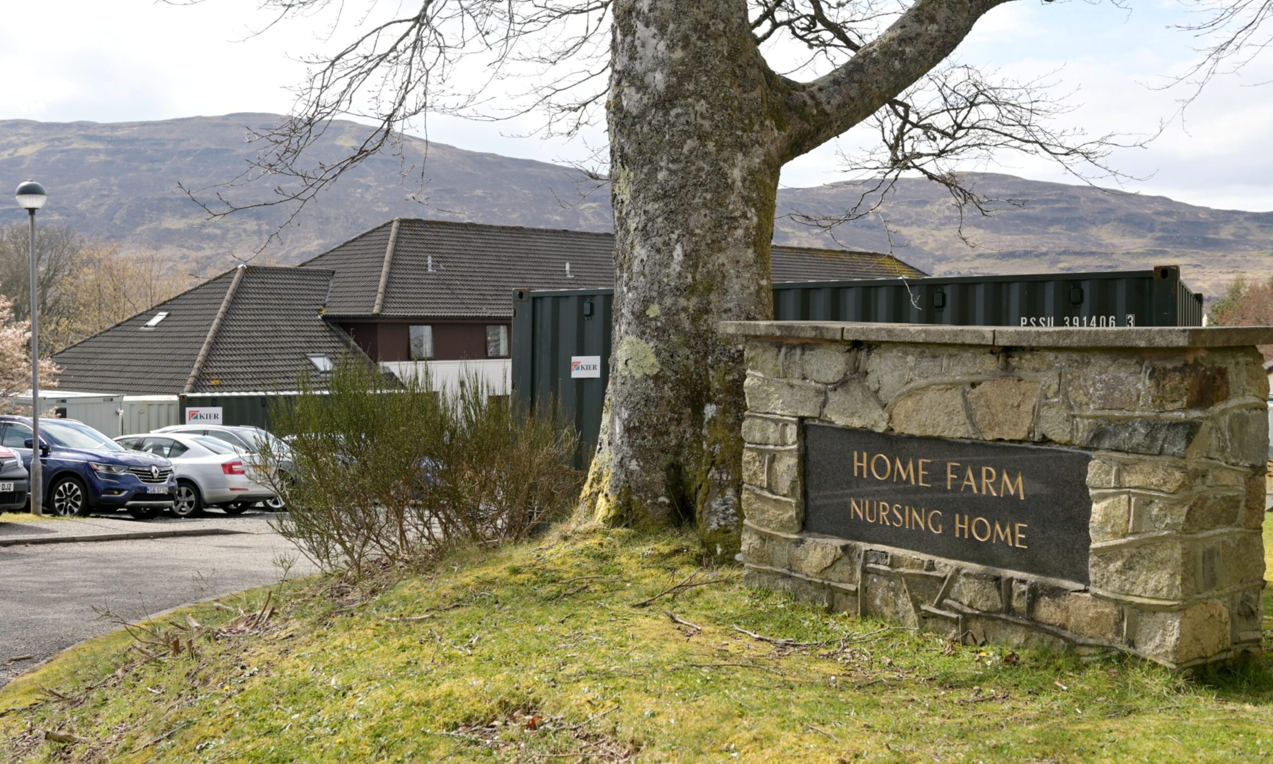 View of entrance to Home Farm with stone sign. 