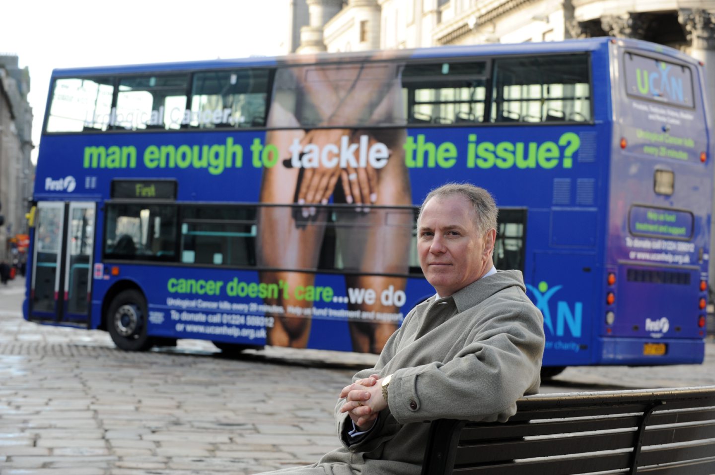 UCAN co-founder Sam McClinton with one of the bus ads in January 2008