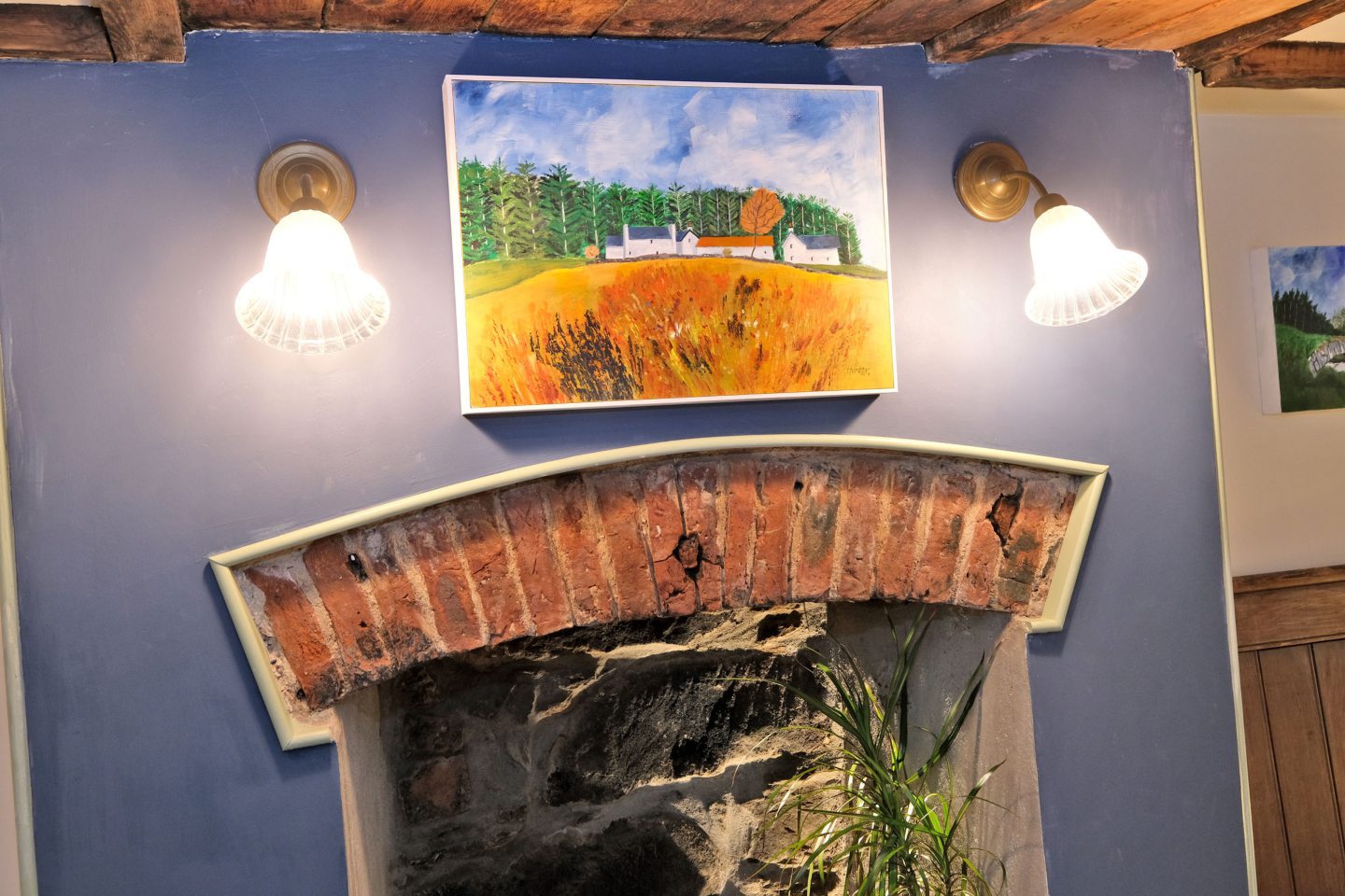 Andrew's beautiful painting hung above the rustic fireplace.