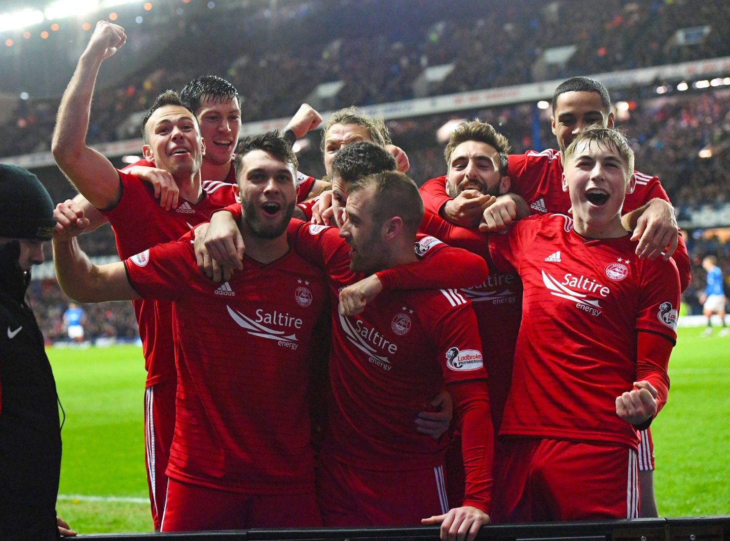Aberdeen's Connor McLennan (left) celebrates his goal with team mates after scoring the second goal in a 2-0 Scottish Cup quarter-final defeat of Rangers at Ibrox in 2019. Image: SNS 