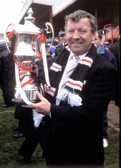 Clyde manager Alex Smith celebrates with the Second Division championship trophy in 1993
